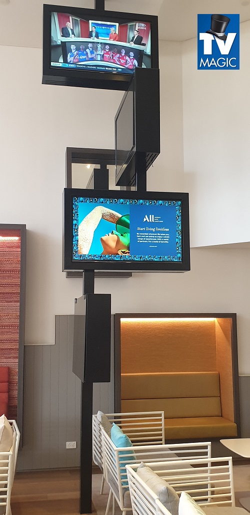 a large tiered multi-TV display in a retail setting