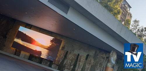 an outdoor extremely large TV display of artwork in the community
