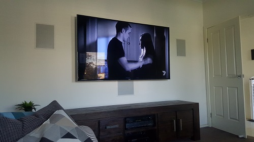 a home cinema setup with built-in surround sound. TV Magic Logo in top left corner