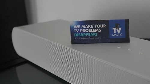 sound bar with a TV Magic business card sitting on top of it