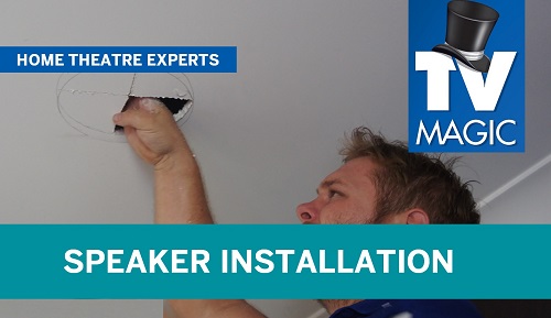 a technician preparing a ceiling for a speaker installation. Caption Speaker installation bottom left and TV Magic logo right hand side