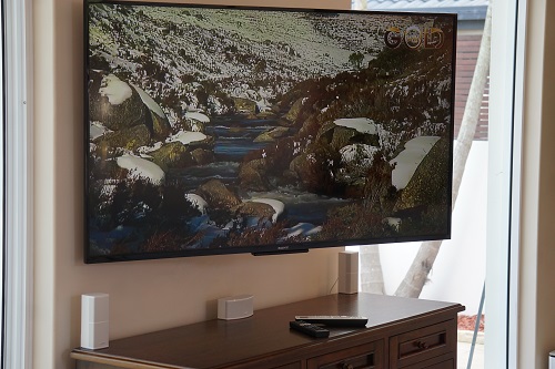 large TV mounted on a wall in a living room