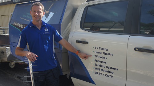 technician pointing at signage on his TV Magic van which says TV Points