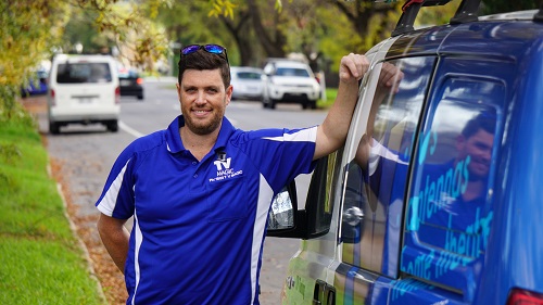 technician standing next to his TV Magic van