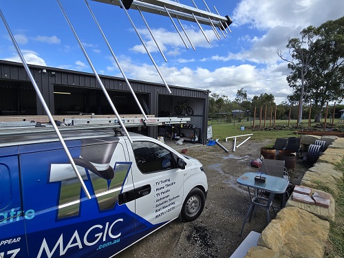 an antenna held up near TV Magic van