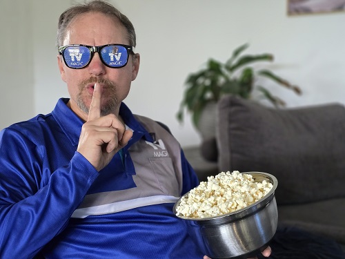 Technician going shhhhhh holding popcorn