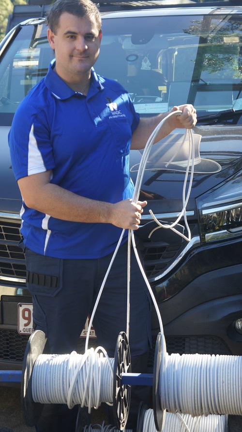 Technician with rolls of cabling for pre-wire fit outs