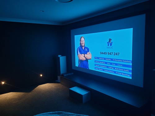 a home cinema screen with technician and services as an image 