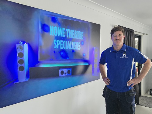 Technician Mitch with a smart TV he installed for a client.