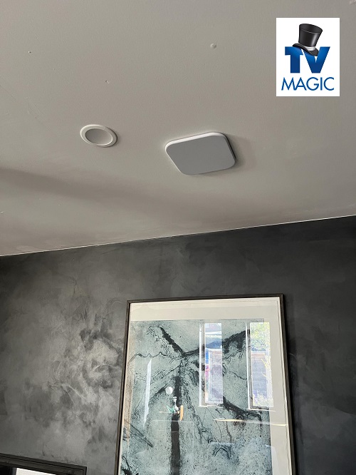 In-ceiling surround sound system with TV Magic logo in top right corner