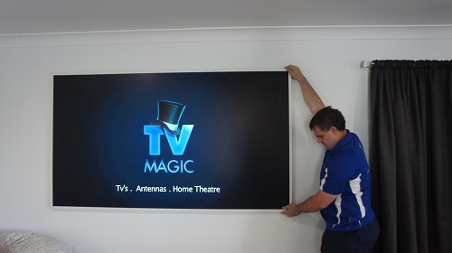 Technician handling a large TV