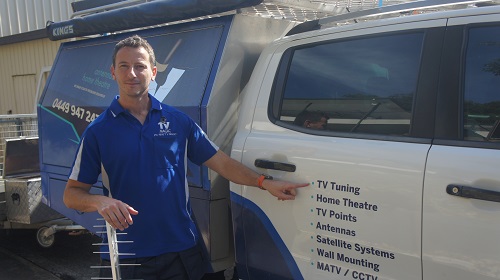 Technician pointing at his antenna service on the side of his van
