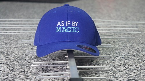 An antenna laying flat with a TV Magic cap on top of it