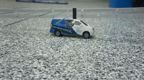 An antenna on top of a mini TV Magic van