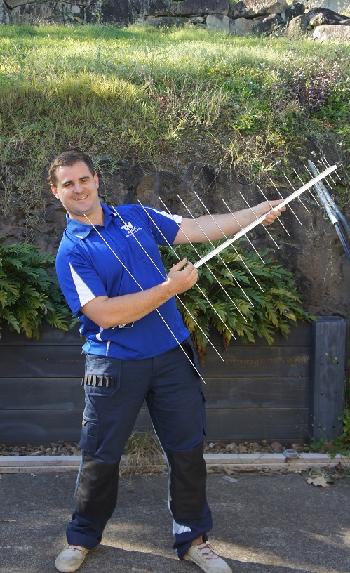 Technician holding up a TV Magic antenna