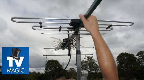 Technician holding an antenna. TV Magic logo in top left corner