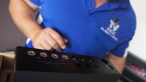 Technician with AV equipment for a home cinema