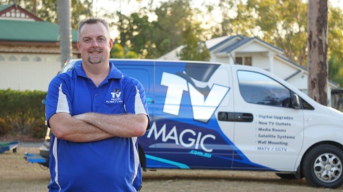 Technician in front of his TV Magic van