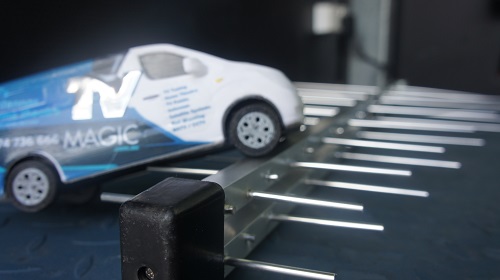 Close up of a mini TV Magic van on top of an antenna
