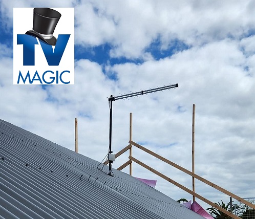 A TV Magic antenna installation on a tin roof. TV Magic logo in top left corner