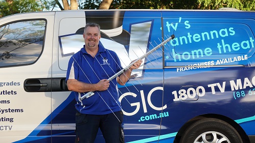 Technician - Anton, with an antenna in front of his van.