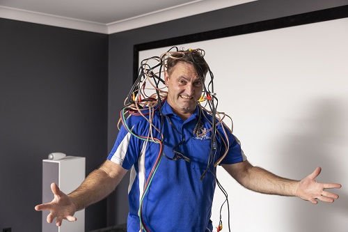 Technician covered in messy cables