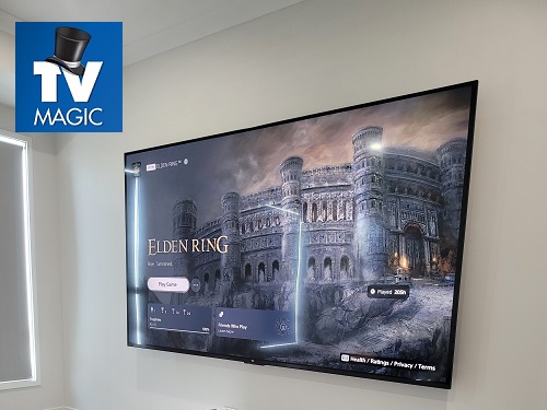 Wall mounted TV. Logo in top left corner