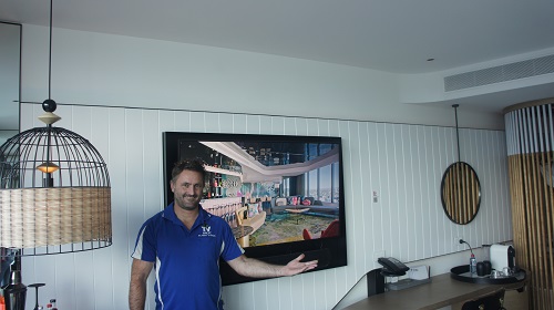 Technician with a TV he wall mounted