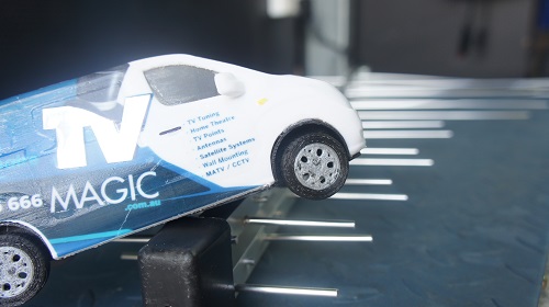 Close up of an antenna with a mini TV Magic van on top of it