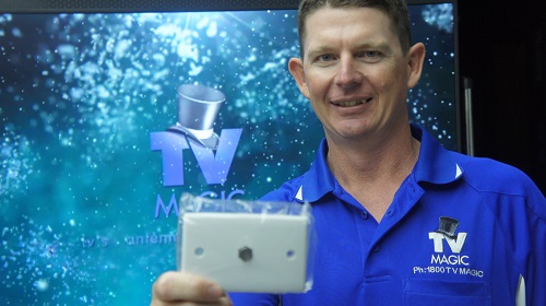 Technician - Brendan, holding up a TV point ready for installation