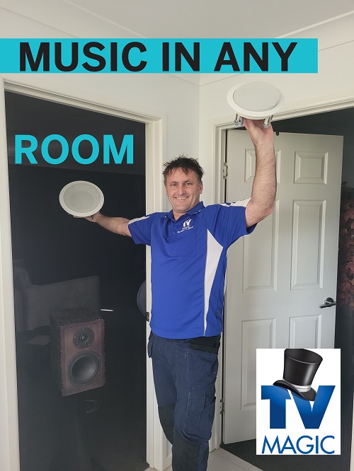 Technician holding up speakers. Caption "Music in any room" TV Magic logo in bottom right corner