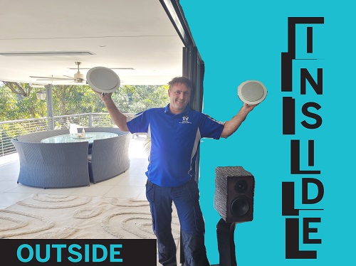 Technician holding speakers up for inside and outside