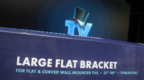 Close up of a TV Magic wall bracket in front of a large screen