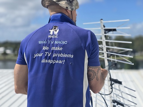 Technician relocating an antenna