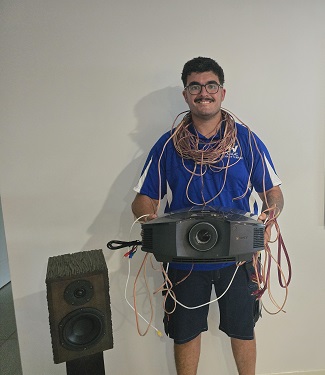 Technician holding a projector with cables all over the place
