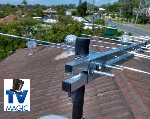 a close up of an antenna installed on a tile roof. TV Magic logo in bottom left corner
