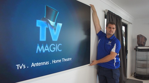 Technician setting up a new TV.