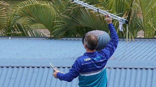 Technician holding up an antenna