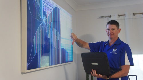 Broken TV being assessed by technician