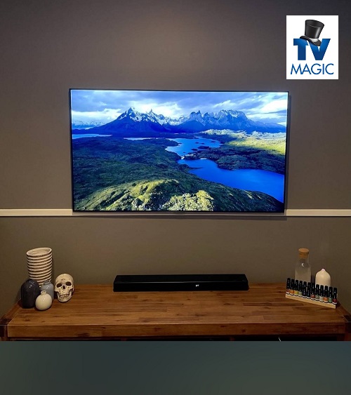 TV installation with sound bar - TV Magic logo in top right corner