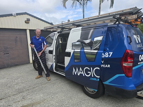 Technician standing next to van with antenna