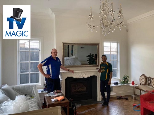 Technician with customer, post hidden TV installation