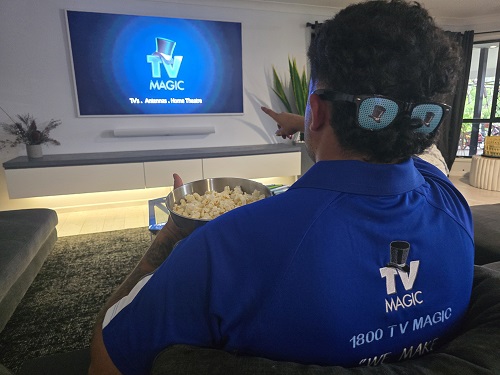 Technician with popcorn and TV Magic sunglasses on the back of his head.