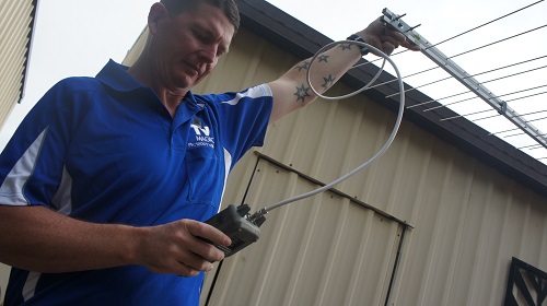 Technician with an antenna and testing equipment