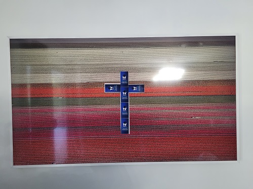 Large screen with a cross on it, made from TV Magic stickers