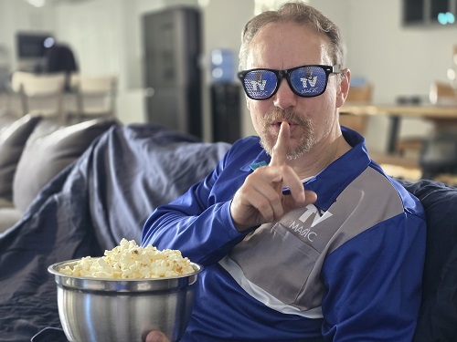 Technician going "shhhh" with bowl of popcorn