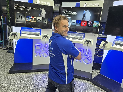 Technician with multiple PlayStation setups for a commercial install