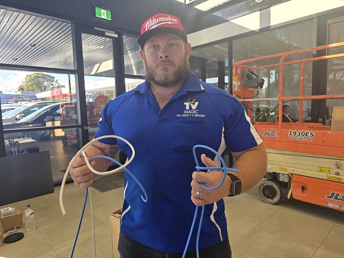 Technician holding cabling in a commercial setting, ready for a pre-wire fit out