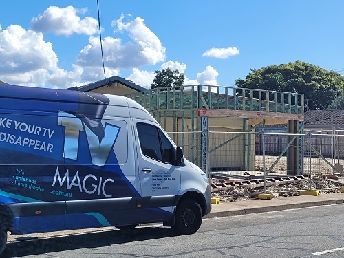 Large TV Magic van in front of a building site