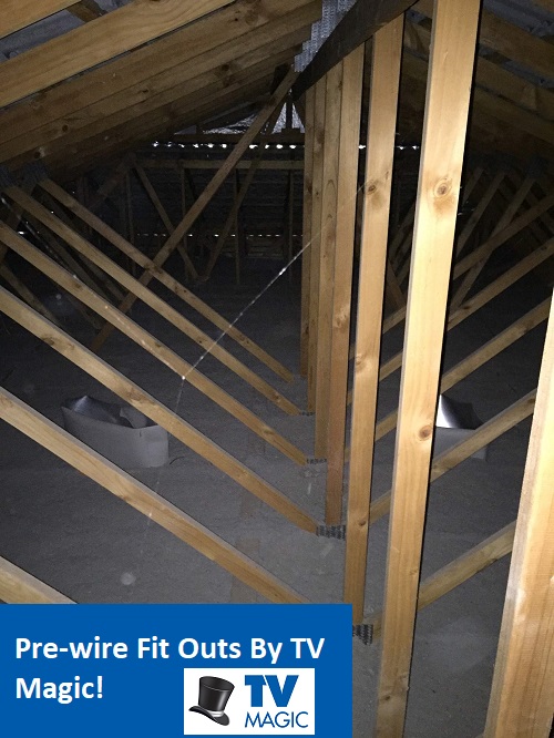 An open ceiling cavity. Caption "Pre-wire Fit Outs By TV Magic"